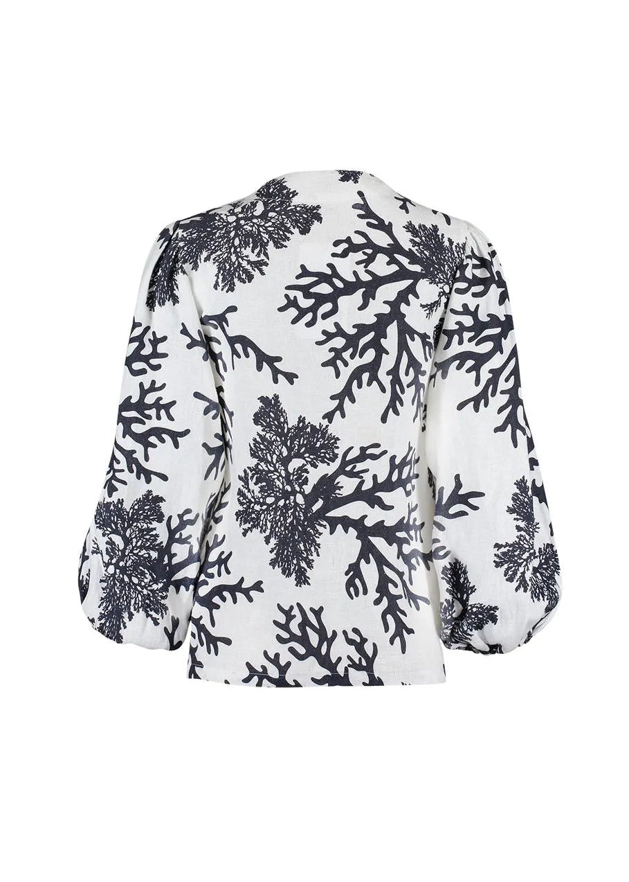 White blouse with black floral pattern on a white background