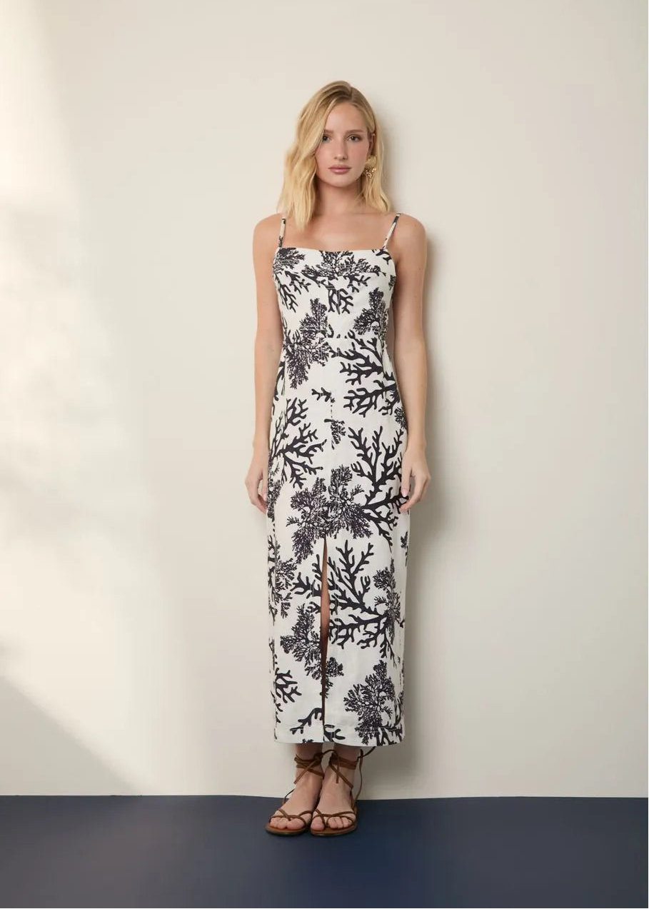 Woman wearing a floral dress against a plain background