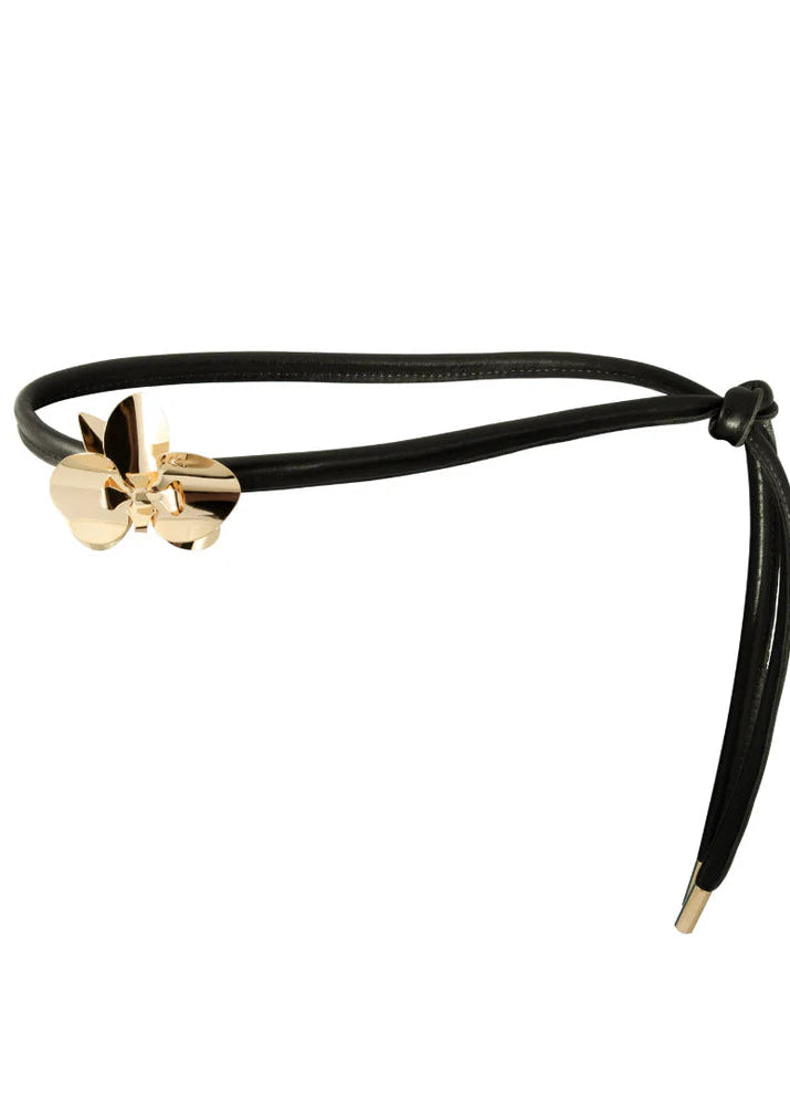 Black headband with gold bow on a white background