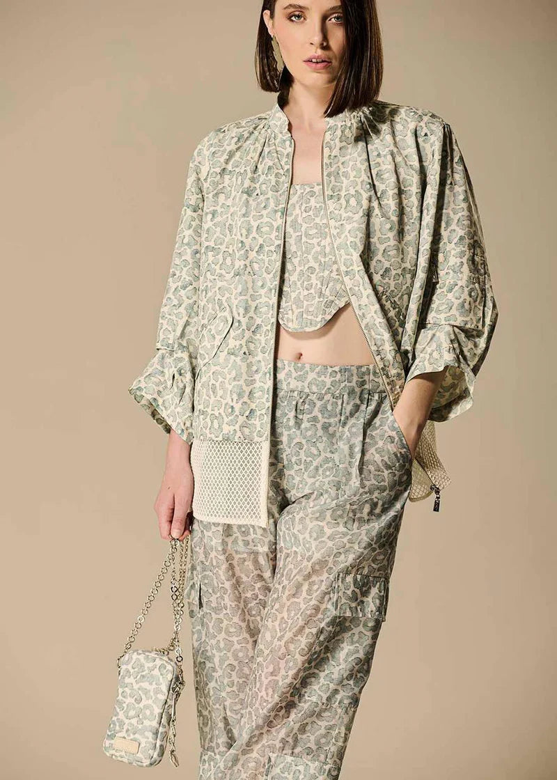 Woman wearing a patterned outfit with a beige background