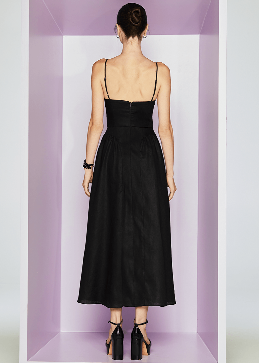 Woman wearing a black dress in a minimalistic setting