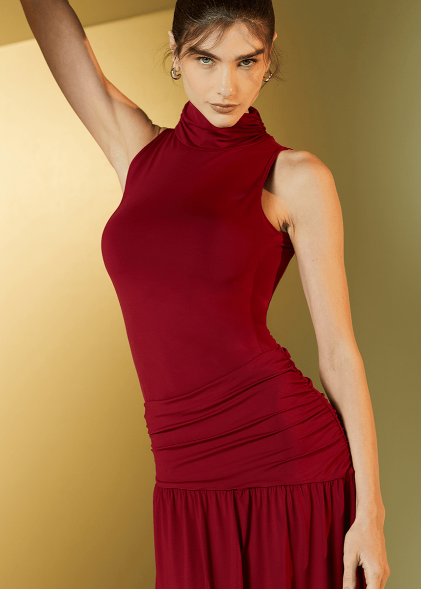 Woman wearing a red dress against a gold background