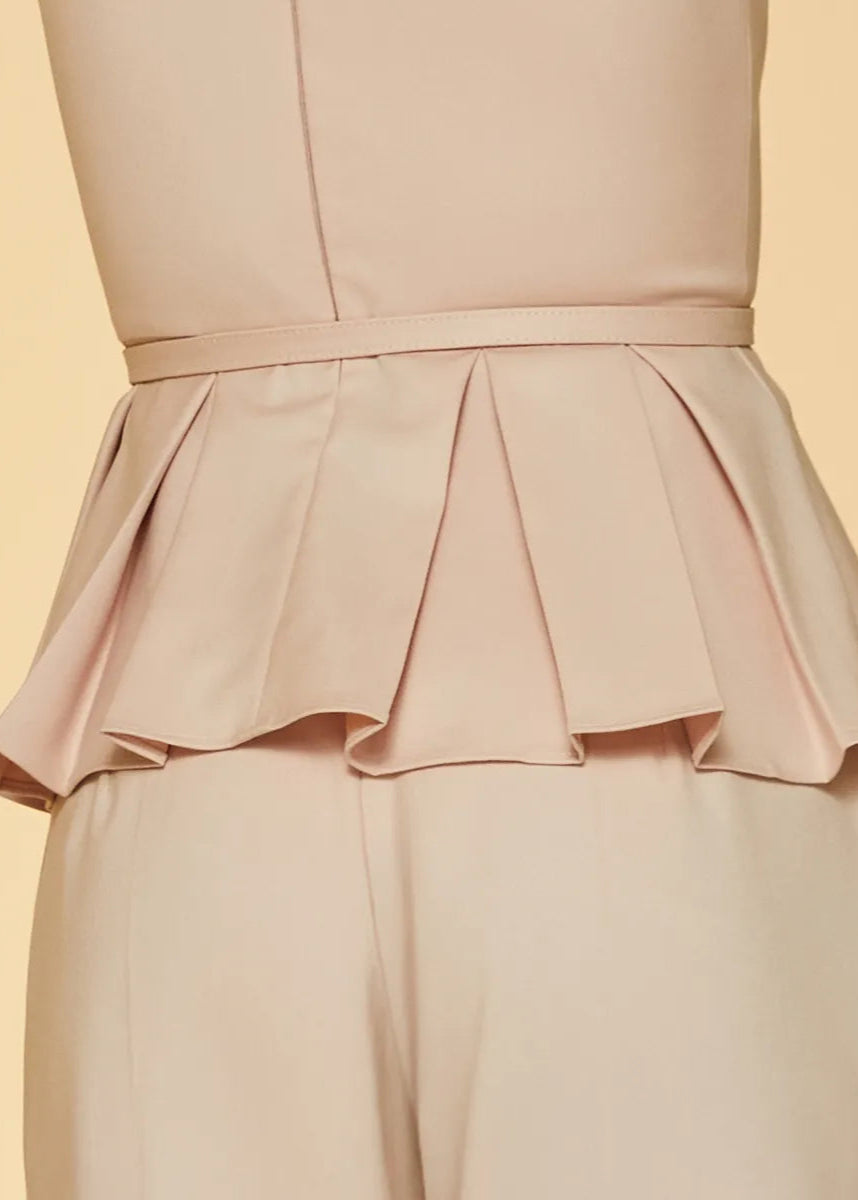 Light pink peplum top and pants on a yellow background