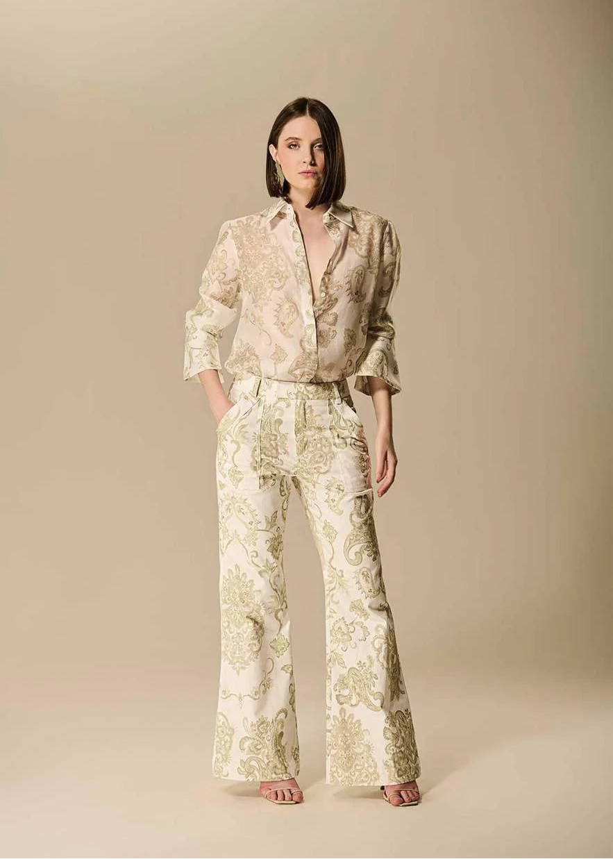 Woman wearing a floral outfit on a beige background