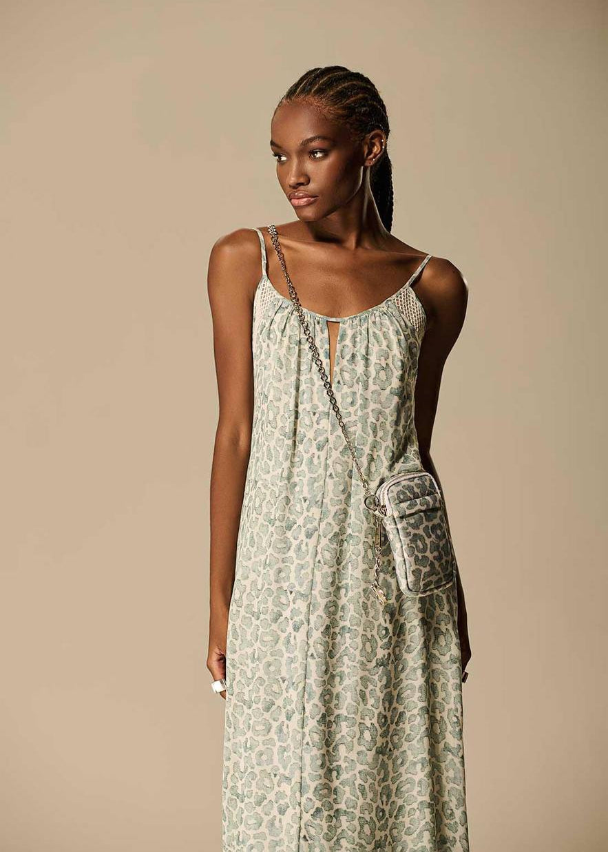 Woman wearing a patterned dress with a beige background
