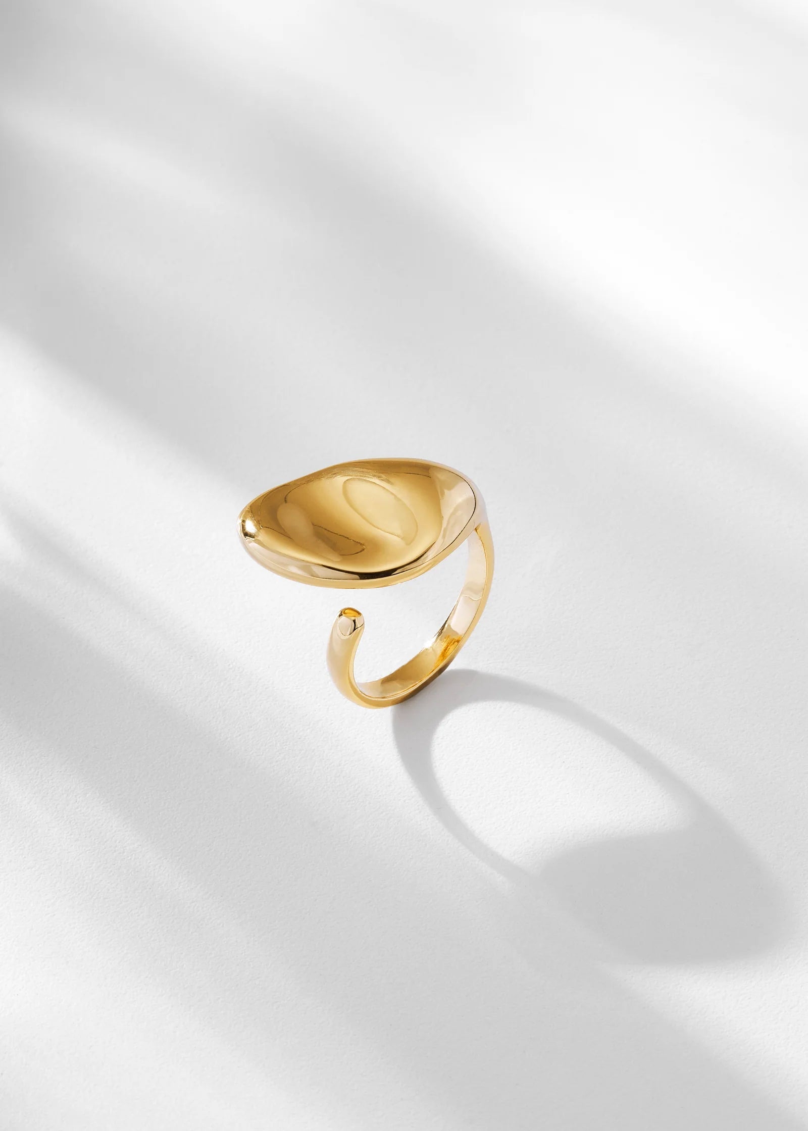 Gold ring on a light gray background