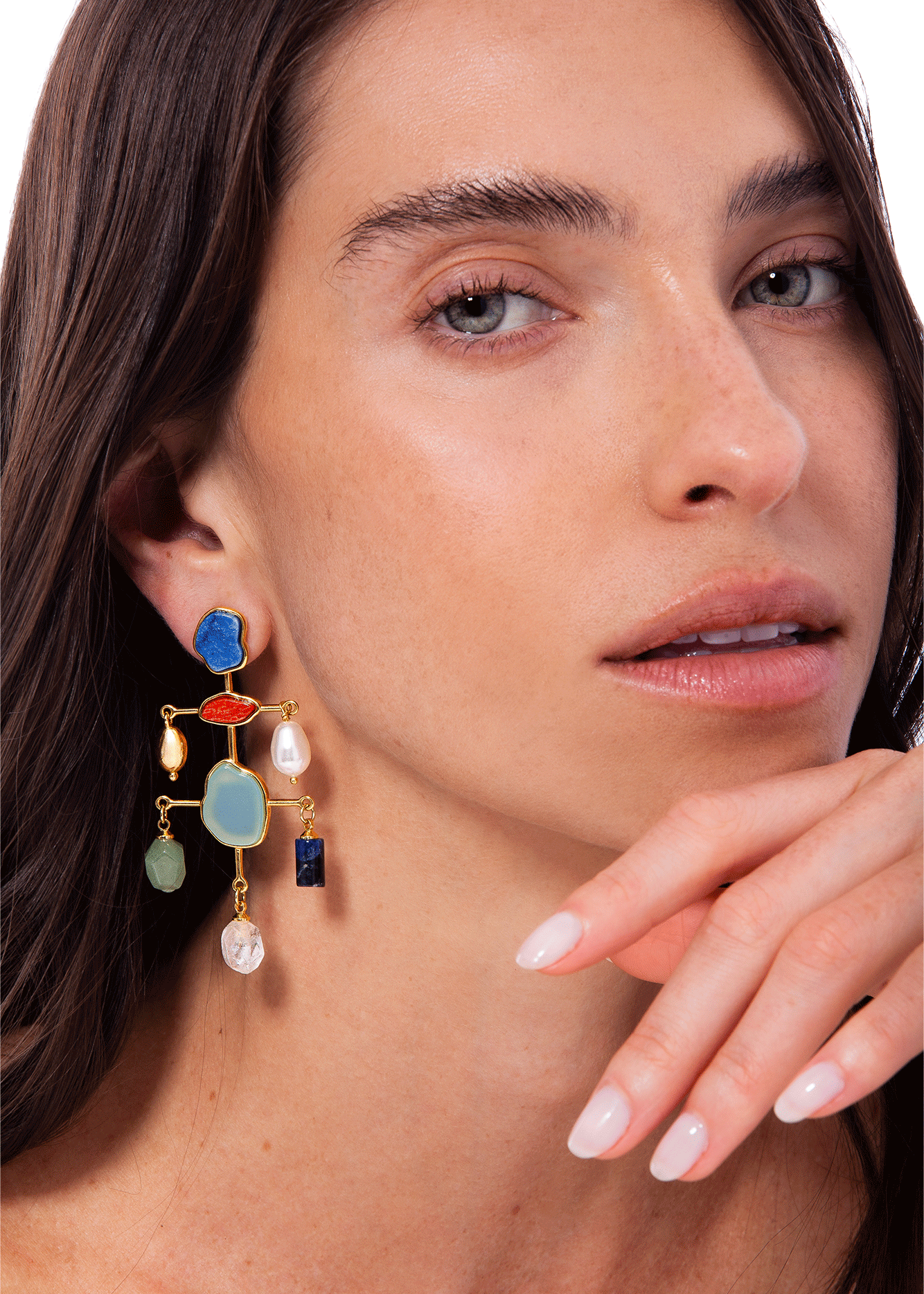 Close-up of a woman wearing colorful earrings with a blurred background