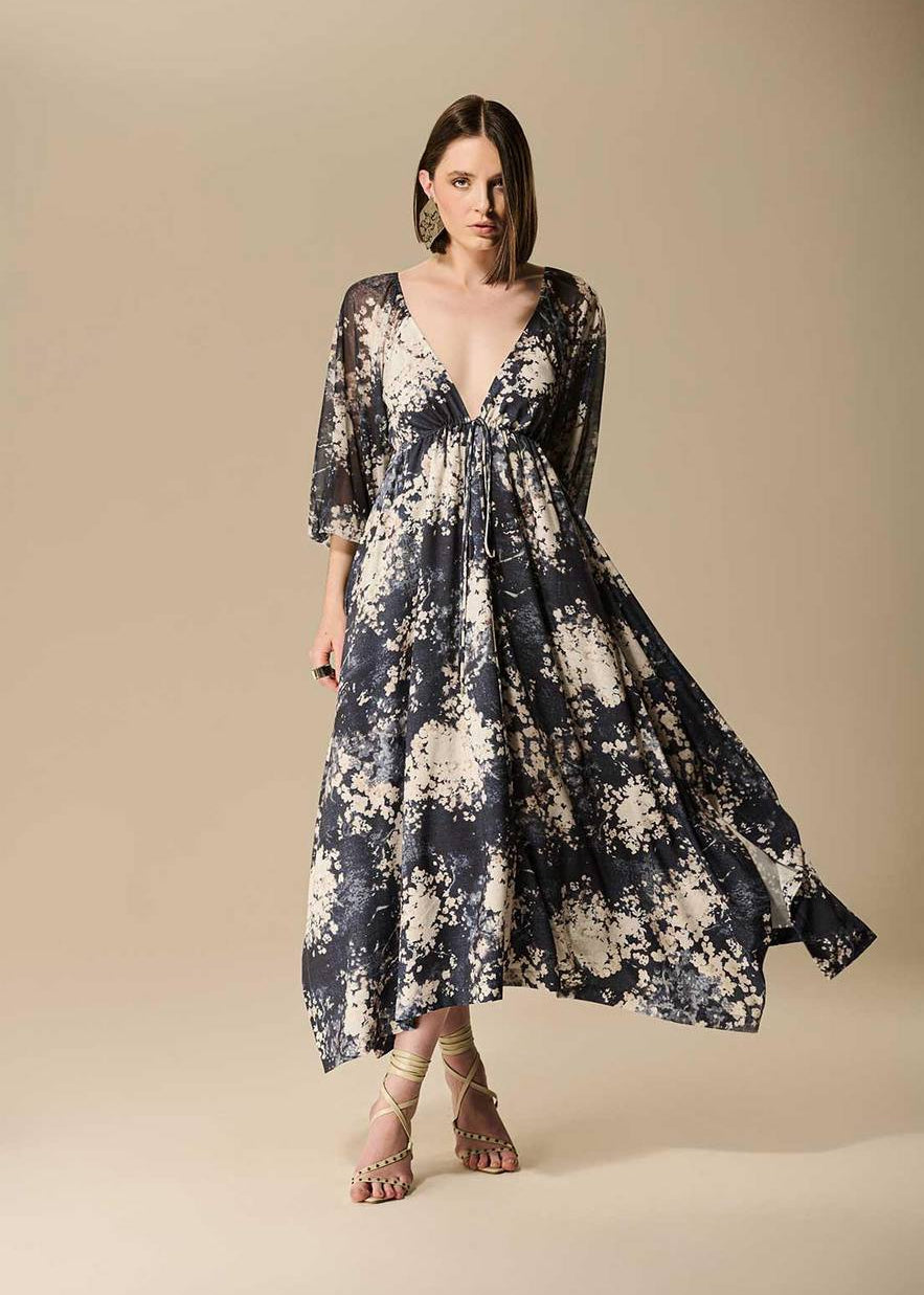 Woman wearing a floral dress against a beige background