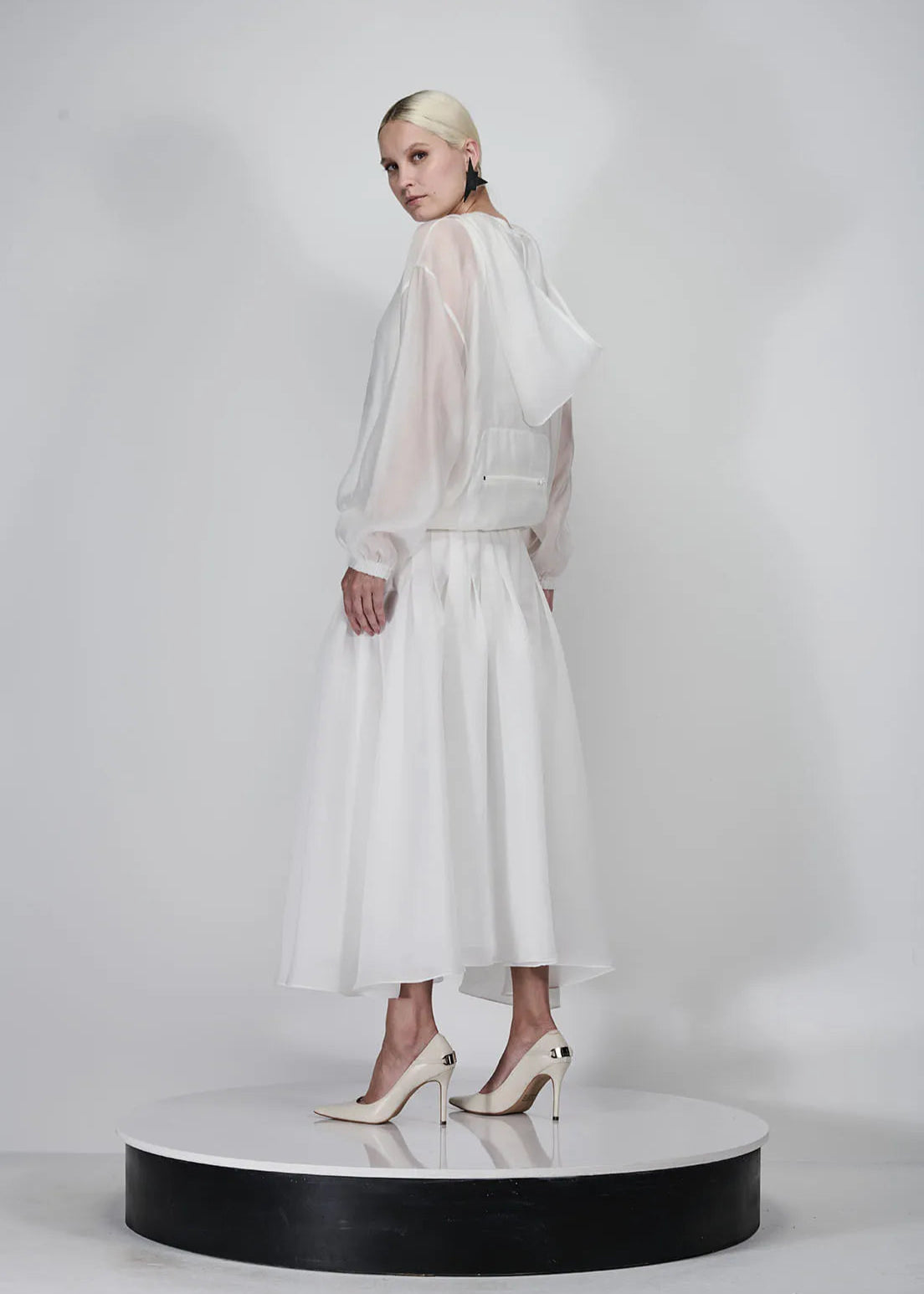 Woman wearing a white dress on a white background