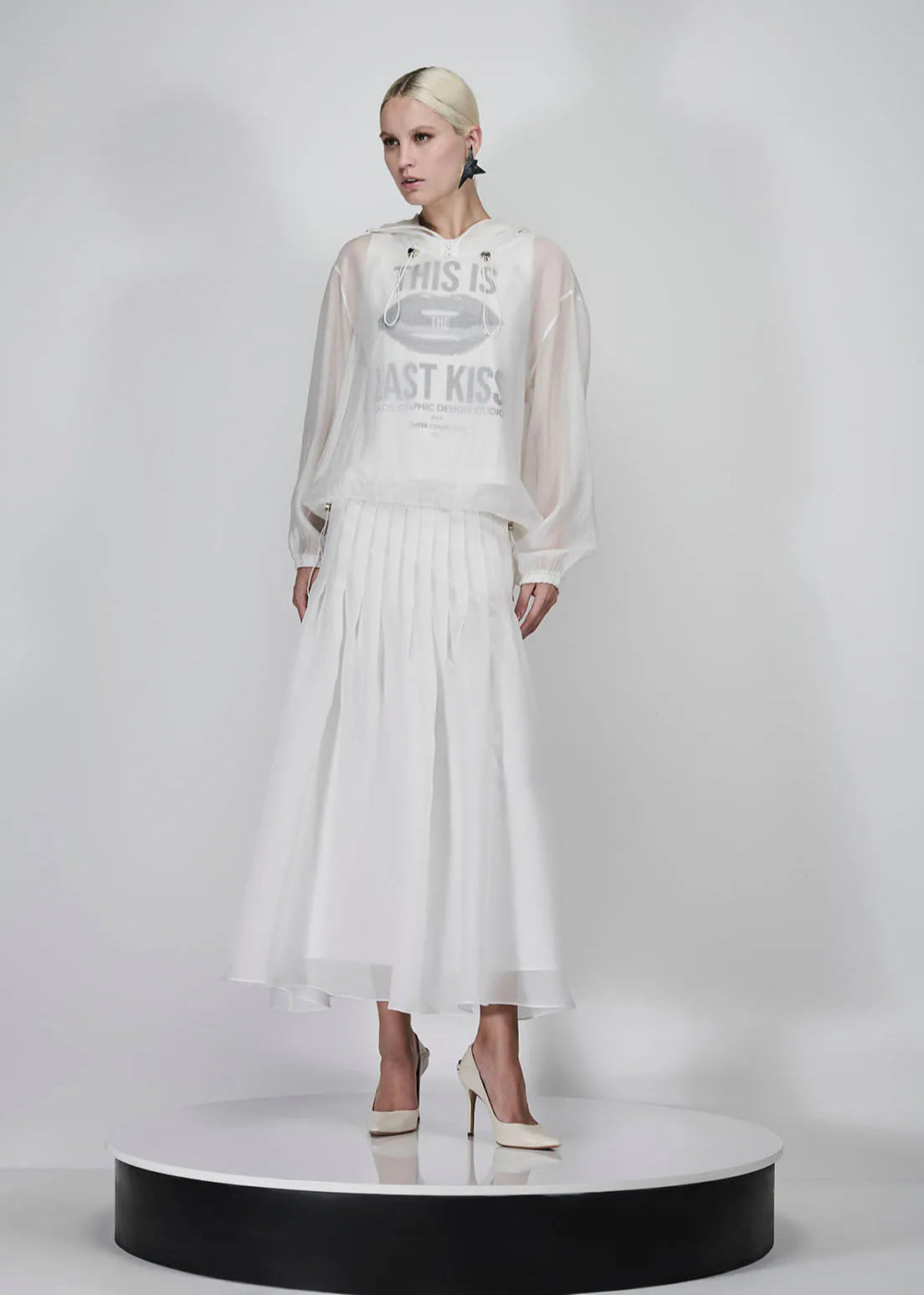 Model wearing a white dress with text on a gray background