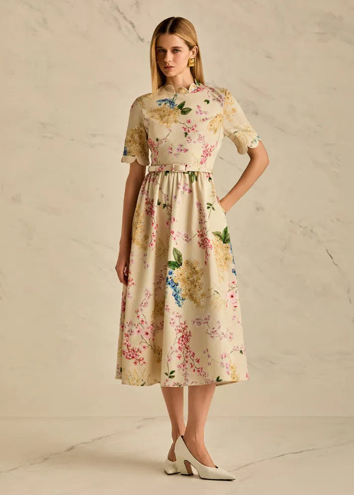 Woman wearing a floral dress against a neutral background