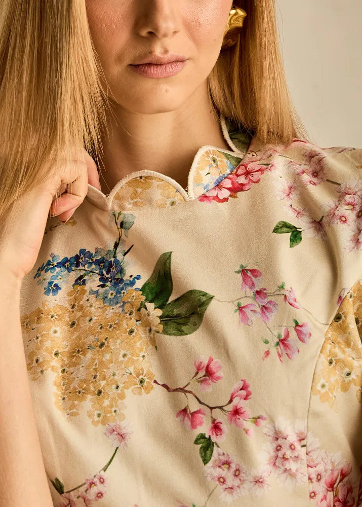 Woman wearing a floral dress with a neutral background