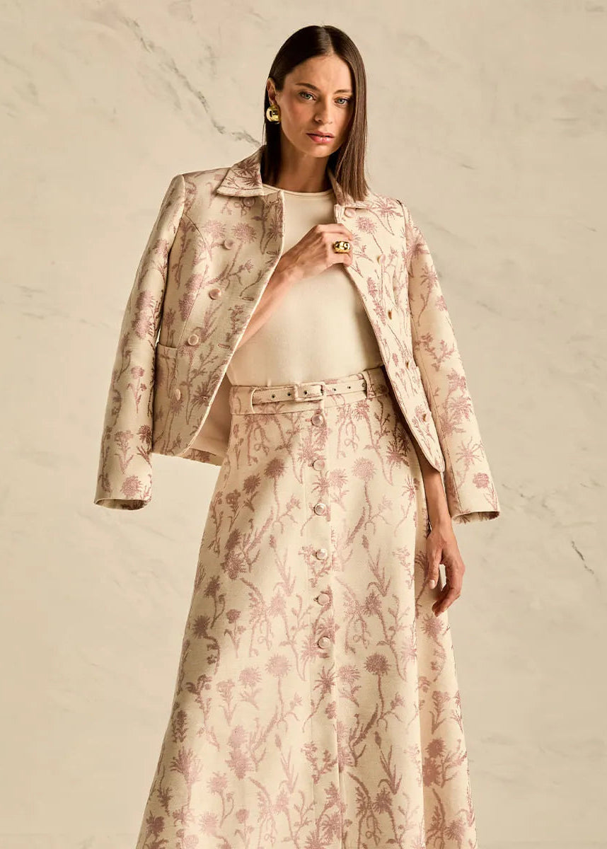Woman wearing a floral outfit on a beige background