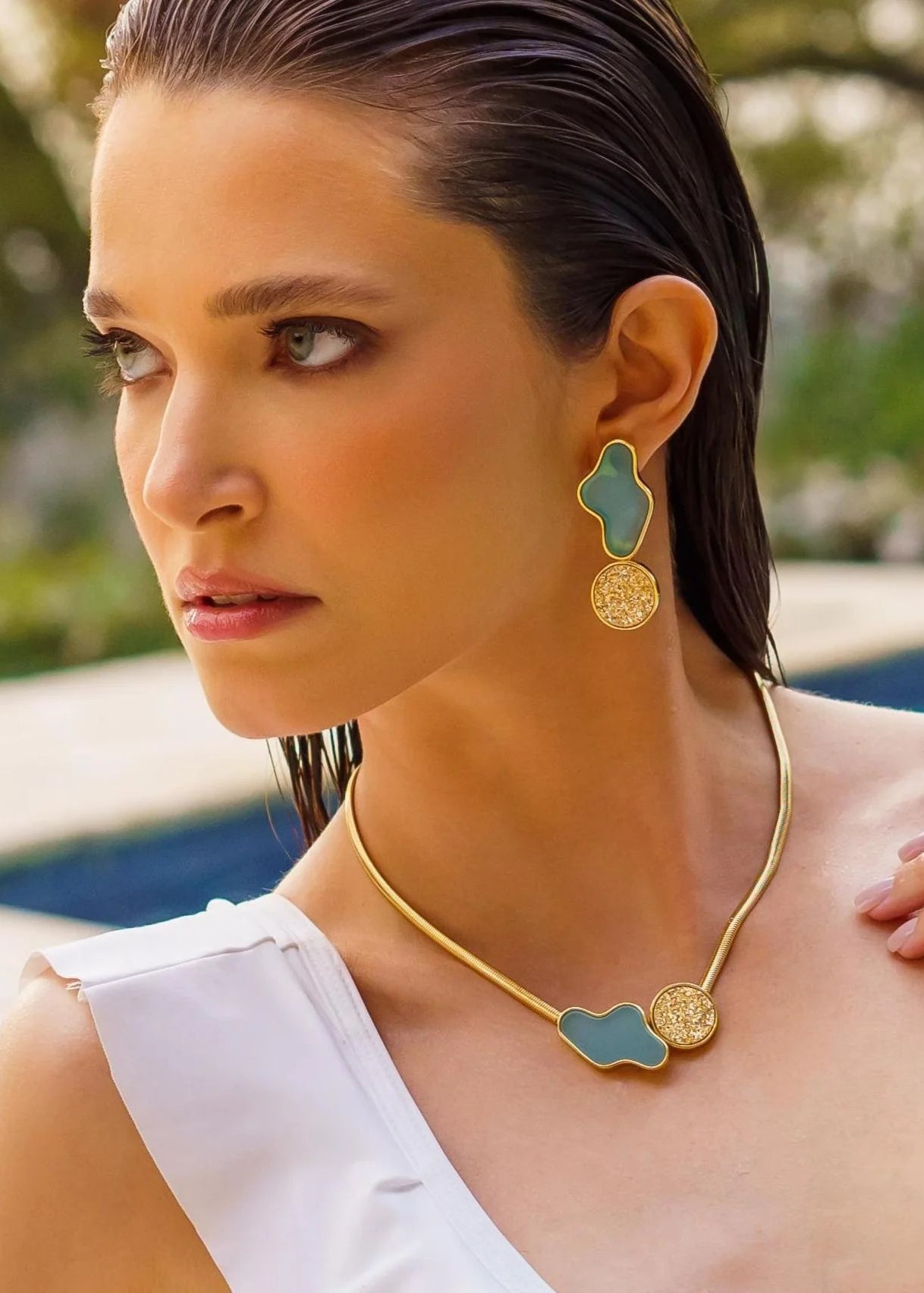 Woman wearing gold and turquoise jewelry outdoors