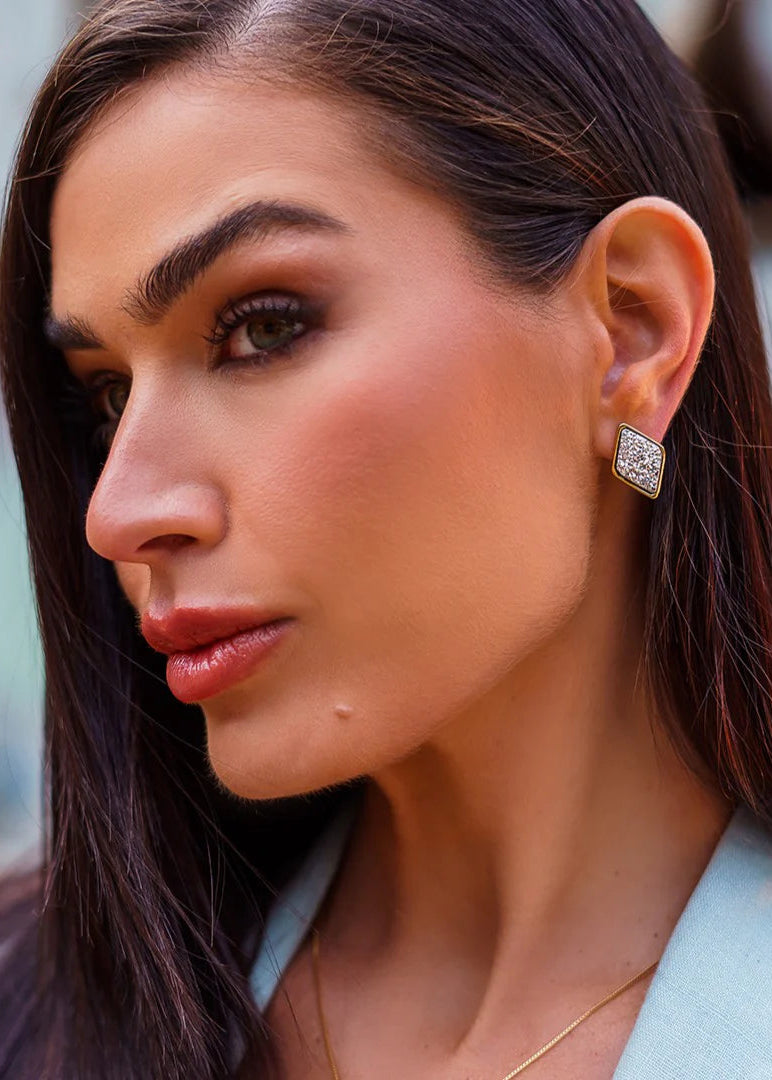 Close-up of a woman wearing a diamond earring with a blurred background
