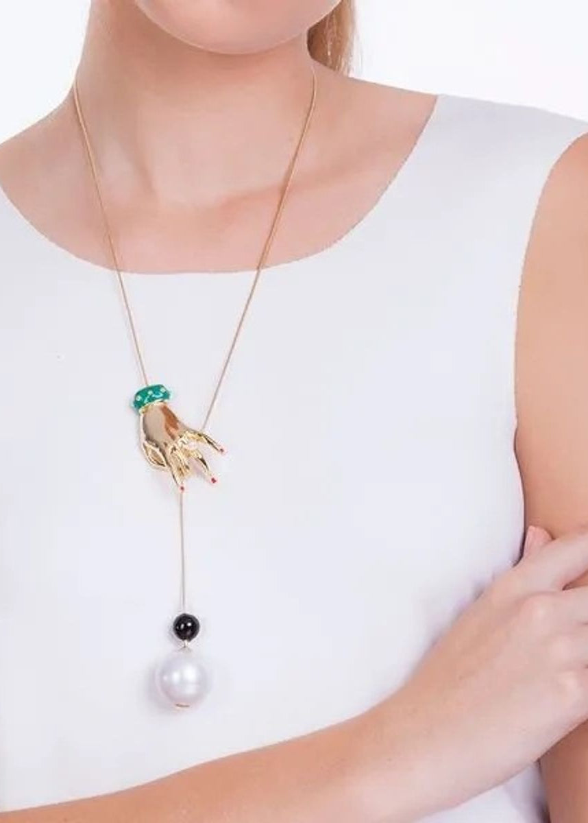 Woman wearing a unique necklace with a white background