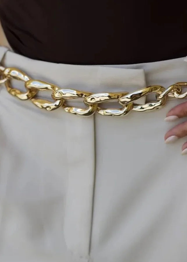 Gold chain belt worn with white pants