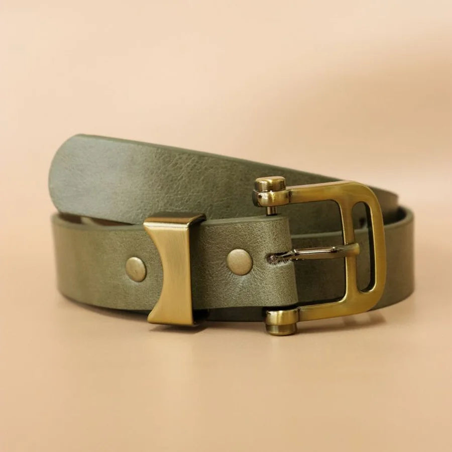 Green leather belt with gold buckle on a beige background