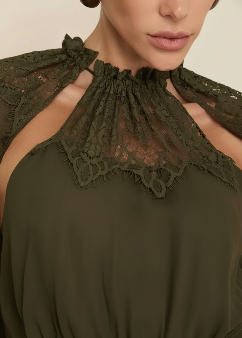 Close-up of a model wearing a dark brown top with a lace high neckline and matching lace shoulder ties against a light beige background.