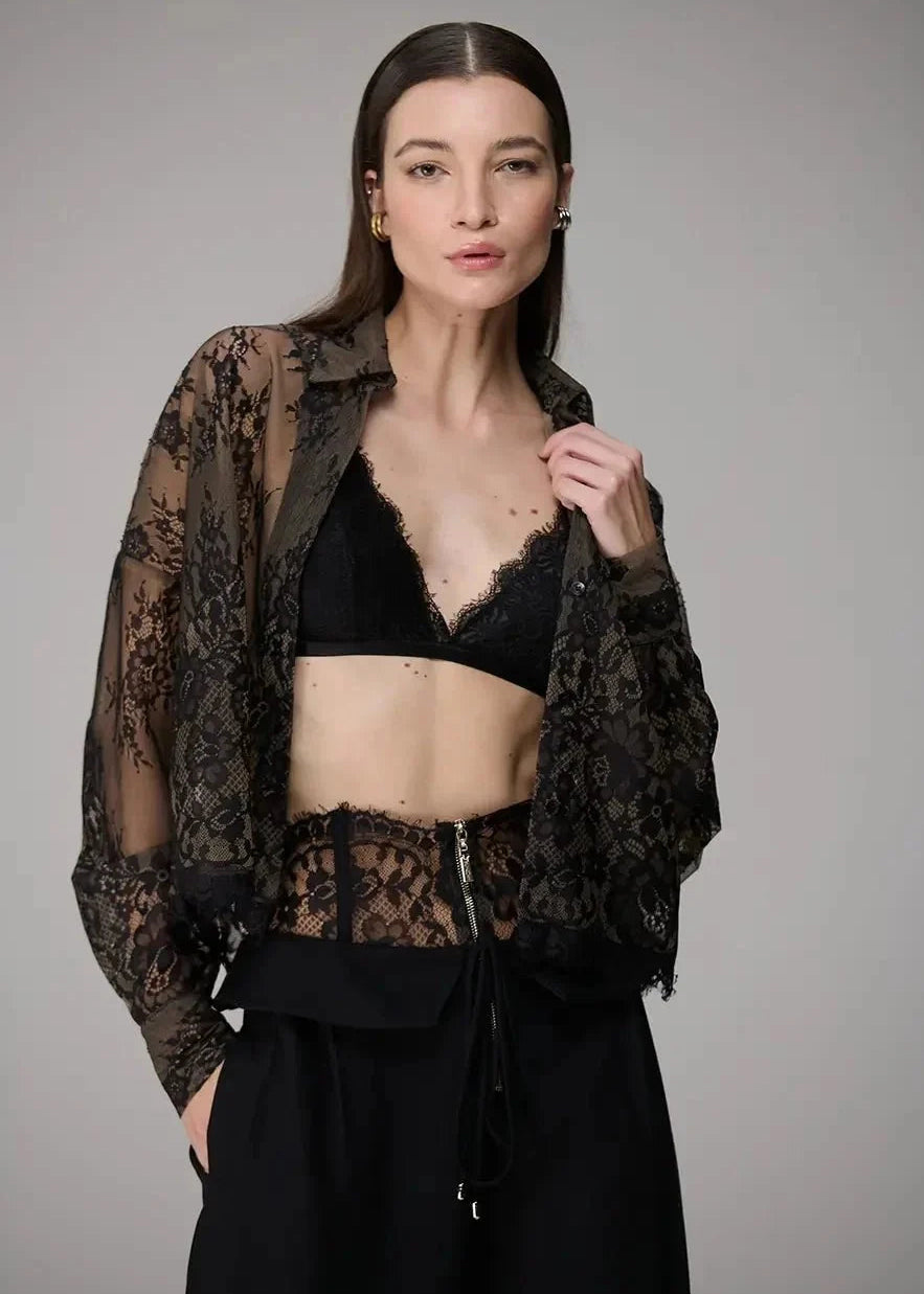 Woman wearing a black lace top and skirt on a gray background