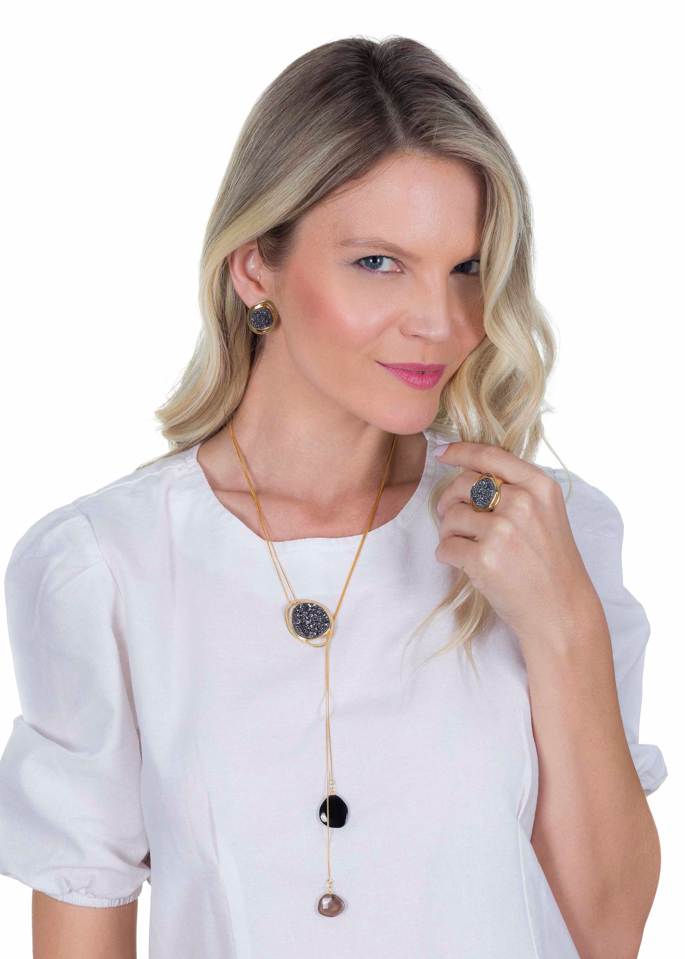Woman wearing a necklace and ring on a white background