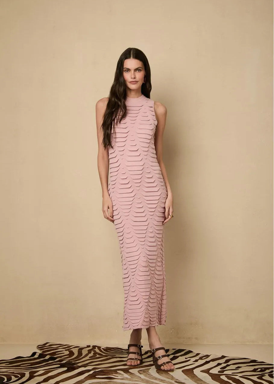 Woman wearing a pink dress against a beige background