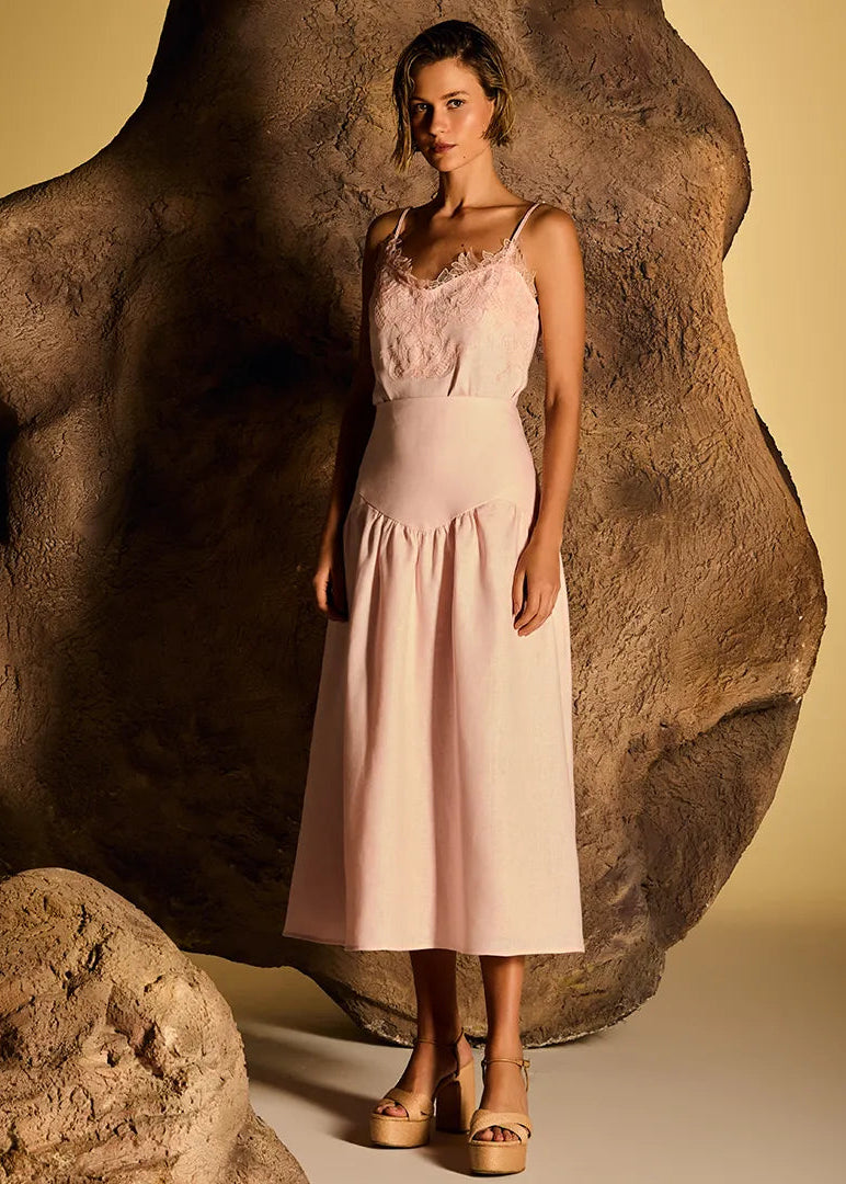 Woman wearing pink outfit against a plain background