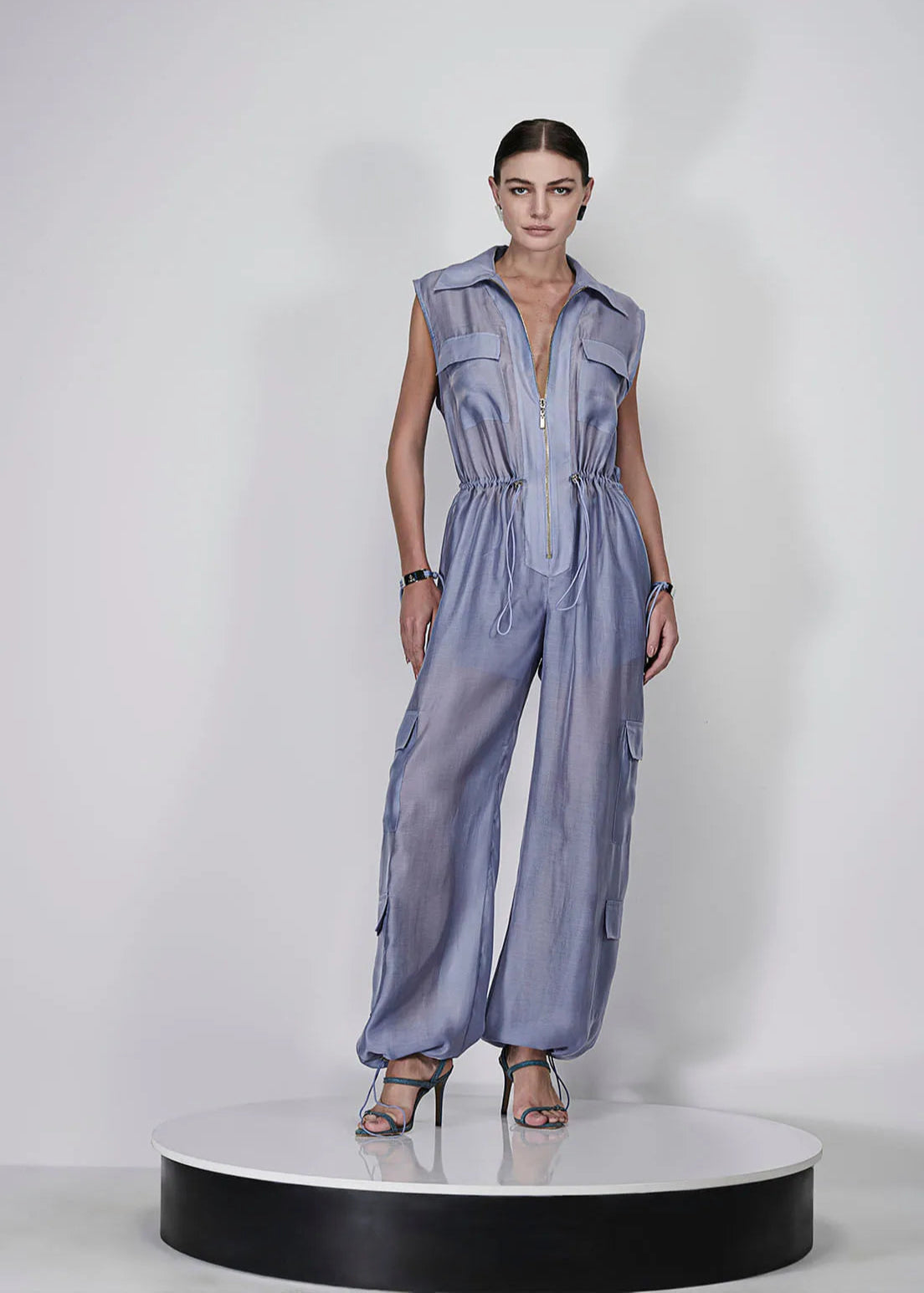 Woman wearing a sleeveless jumpsuit on a white background