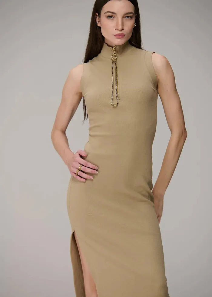Woman wearing a beige sleeveless dress with a high slit on a gray background