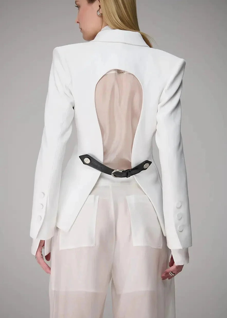 White blazer with sheer panels and a black belt on a gray background