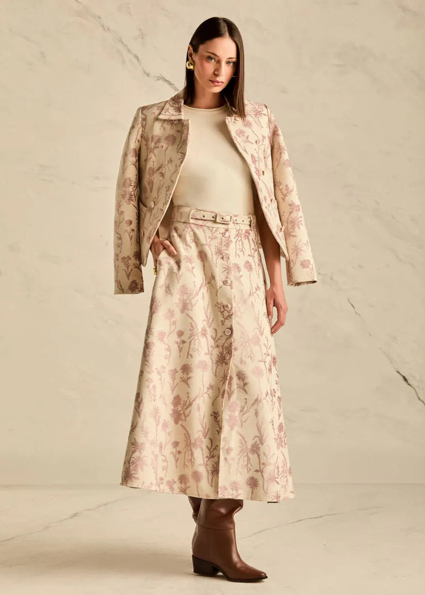 Woman wearing a floral suit with a neutral background
