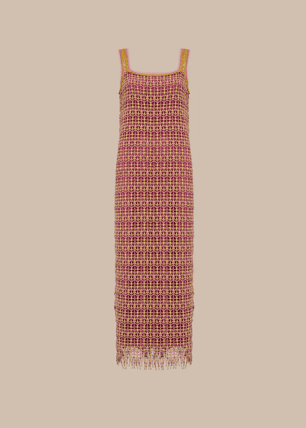 Long patterned dress with fringe on a beige background