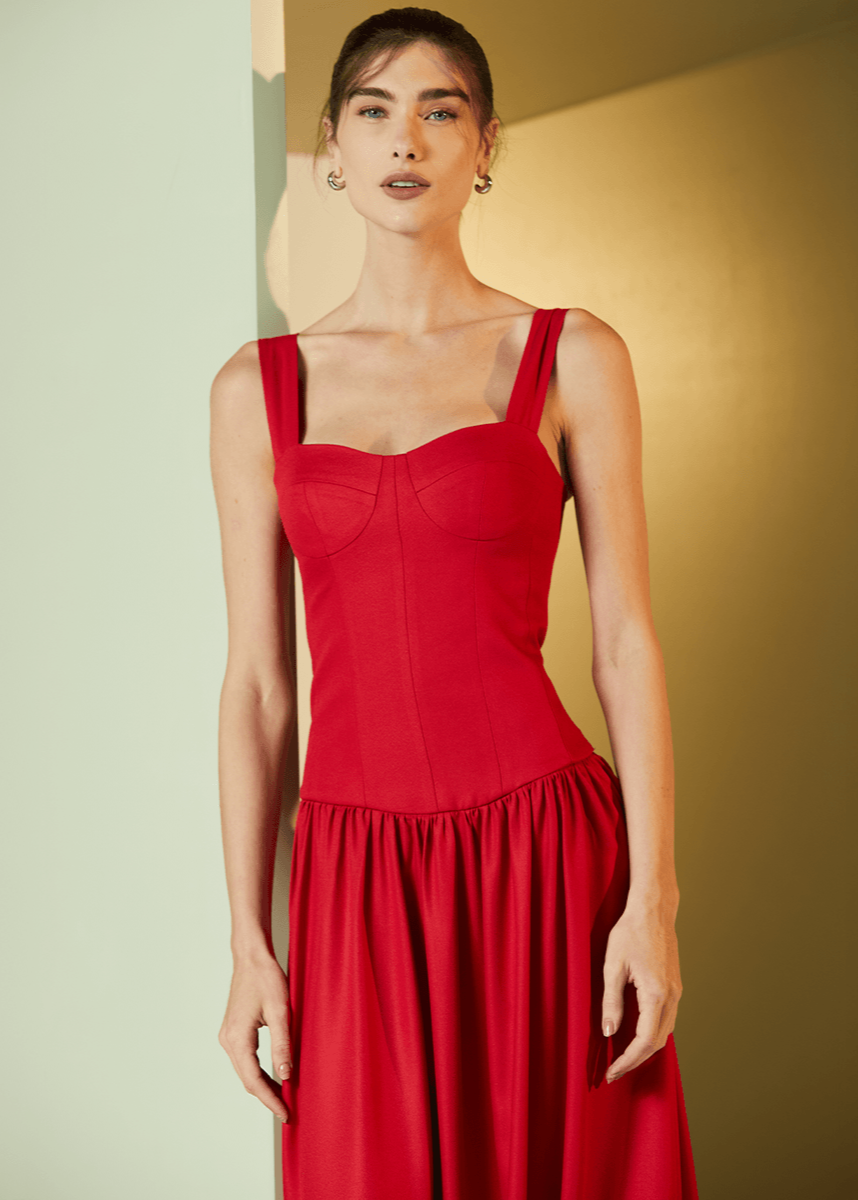 Woman wearing a red dress against a neutral background