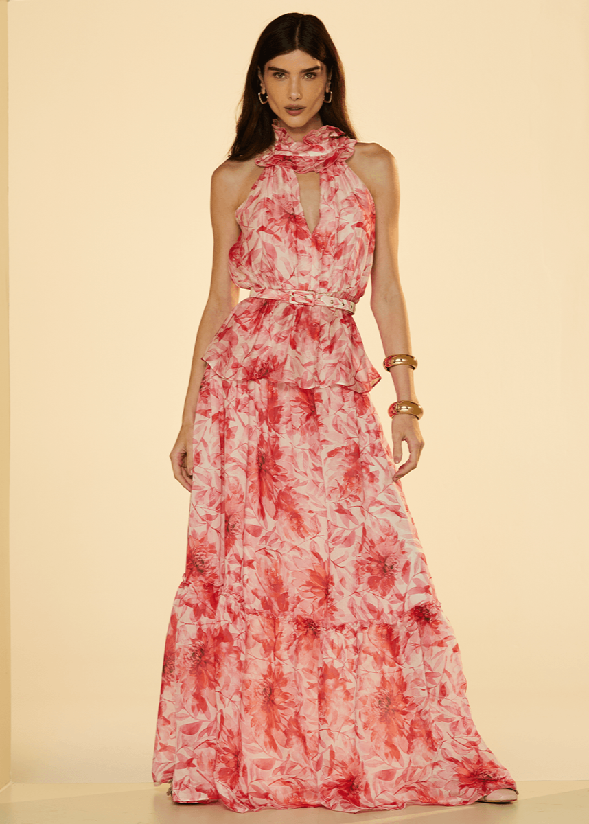 Woman wearing a red and white floral dress against a beige background