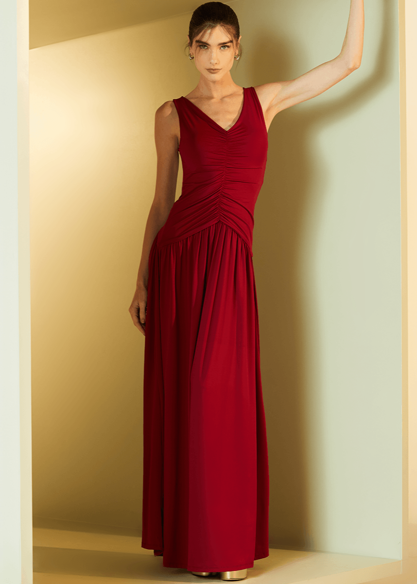 Woman wearing a red evening gown against a neutral background