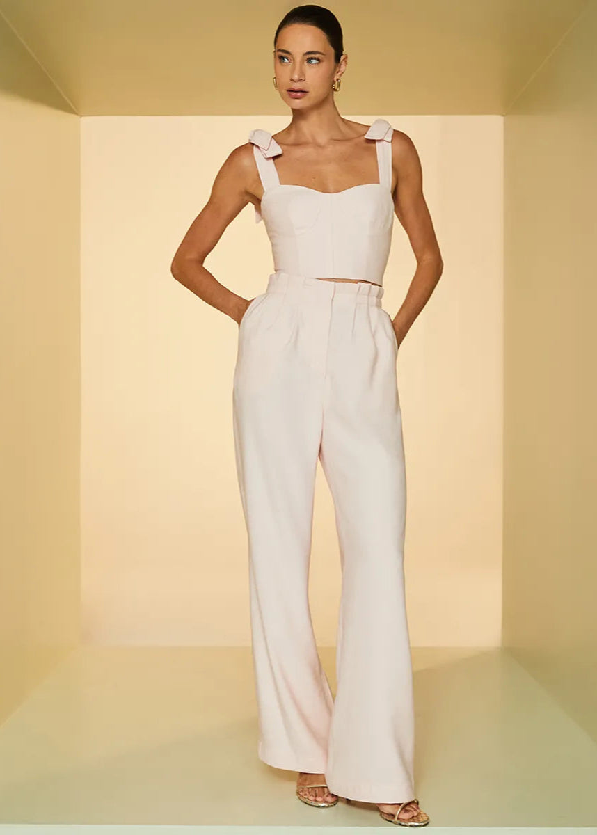 Woman wearing a white outfit with a plain background