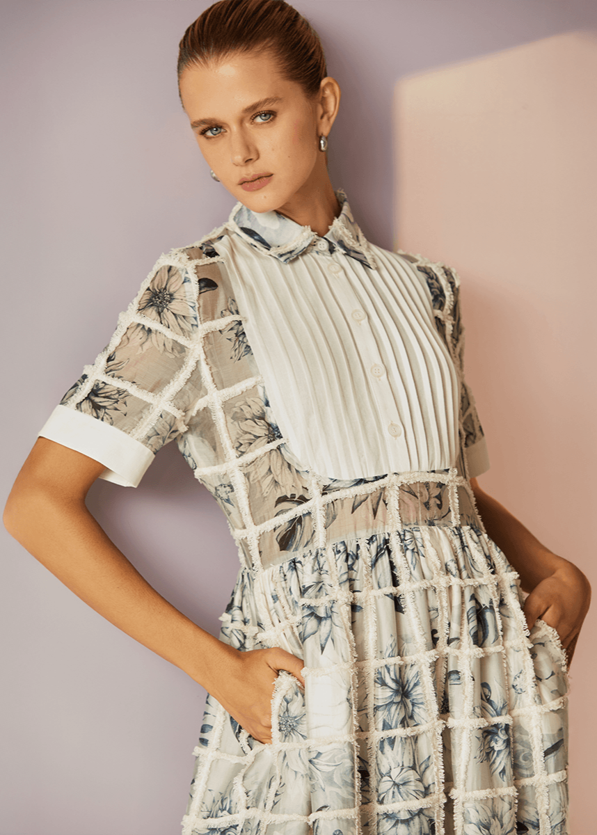 Woman wearing a floral dress with a neutral background