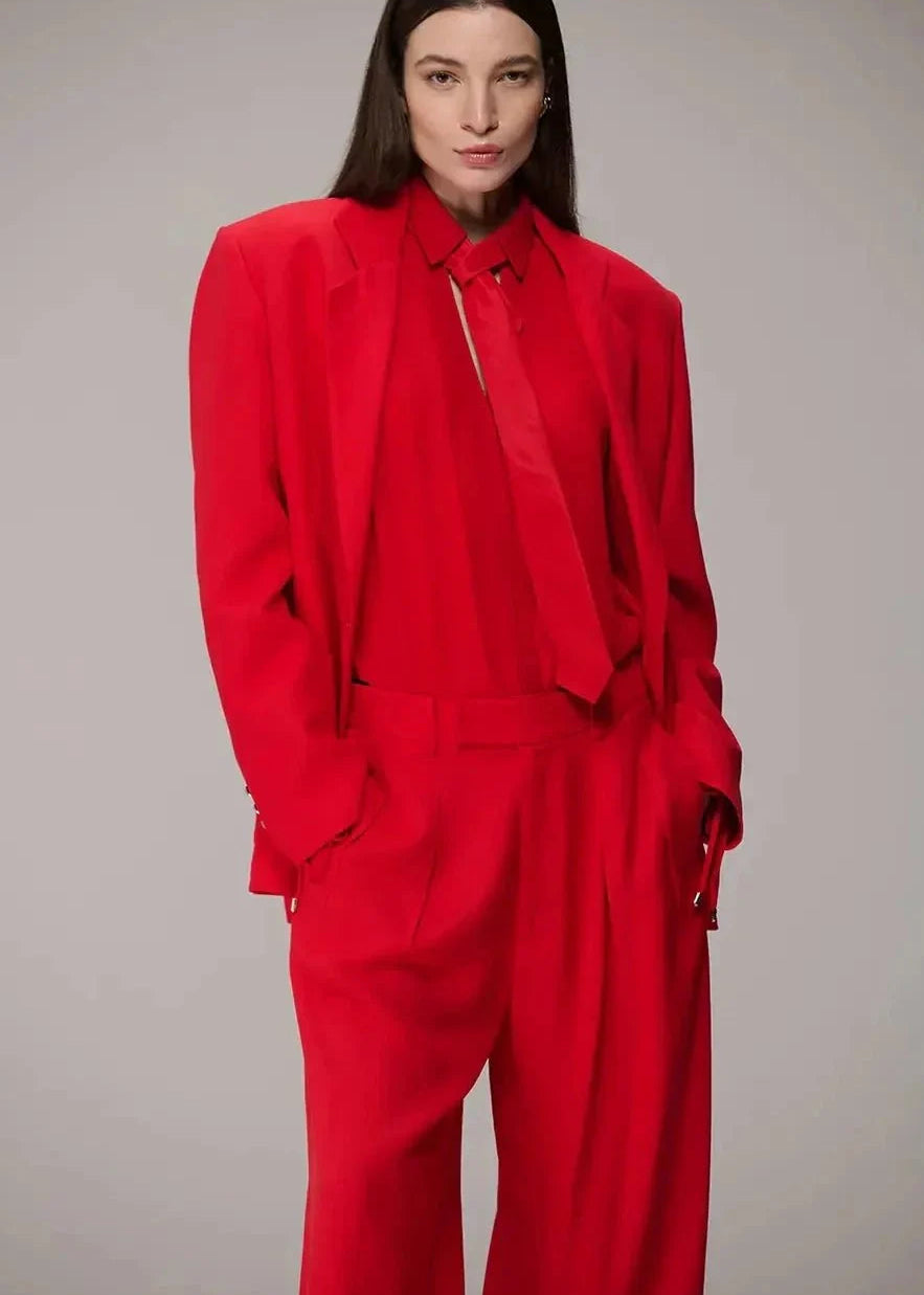 Person wearing a red outfit against a gray background