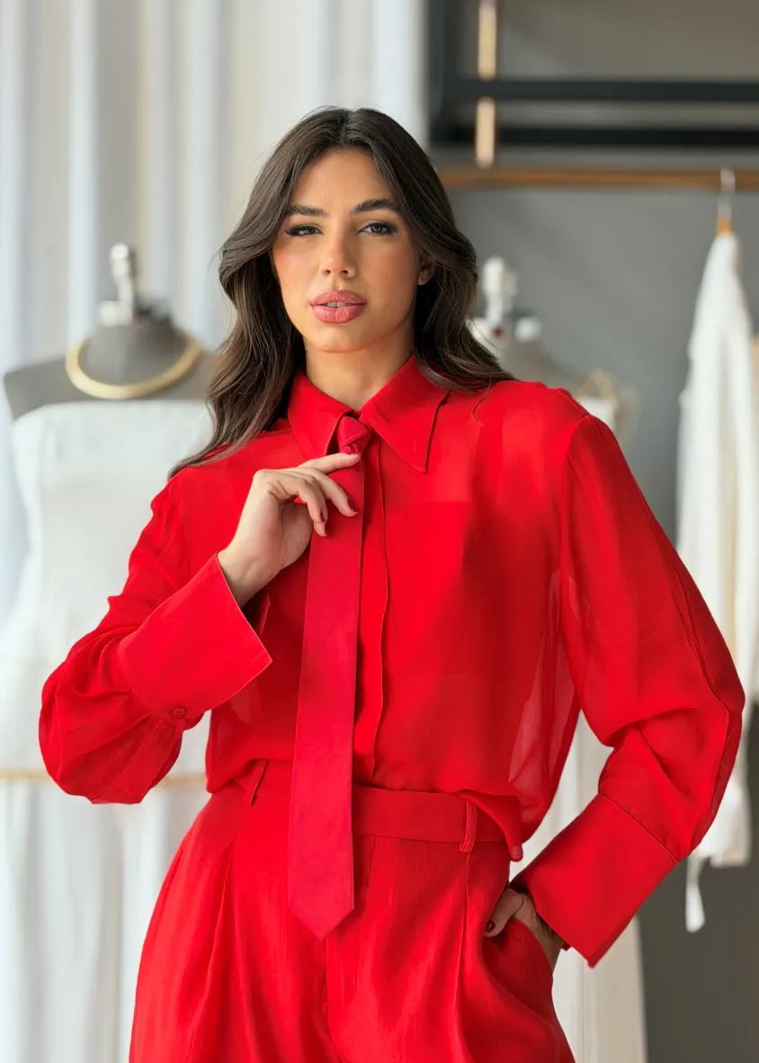 Woman wearing a red outfit in a clothing store setting