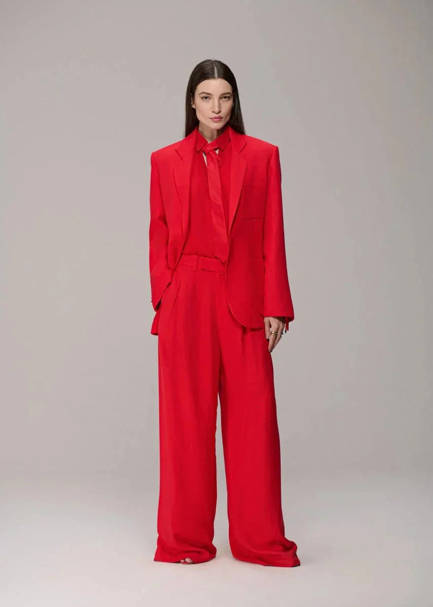 Person wearing a red suit on a plain background