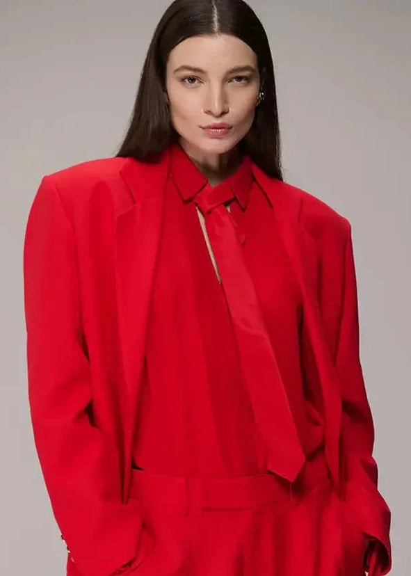Person wearing a red outfit against a gray background