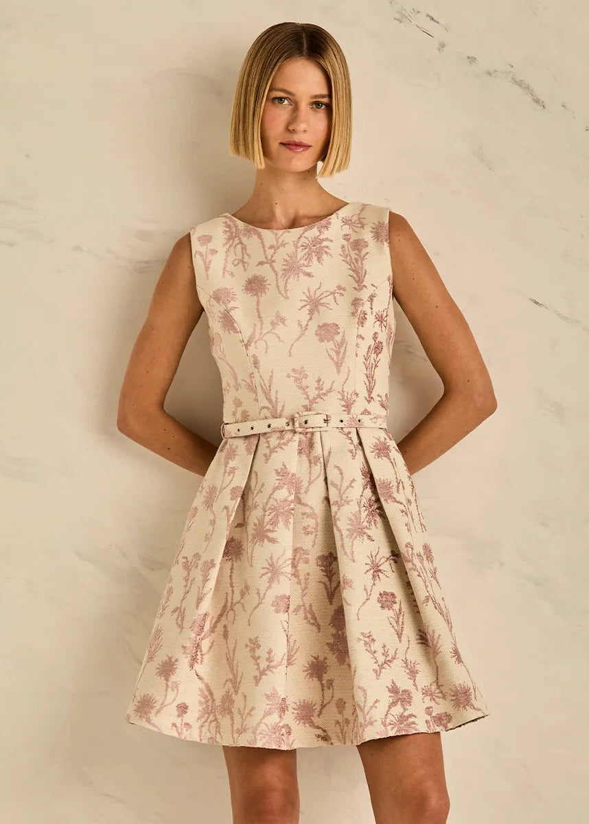Woman wearing a floral dress against a neutral background
