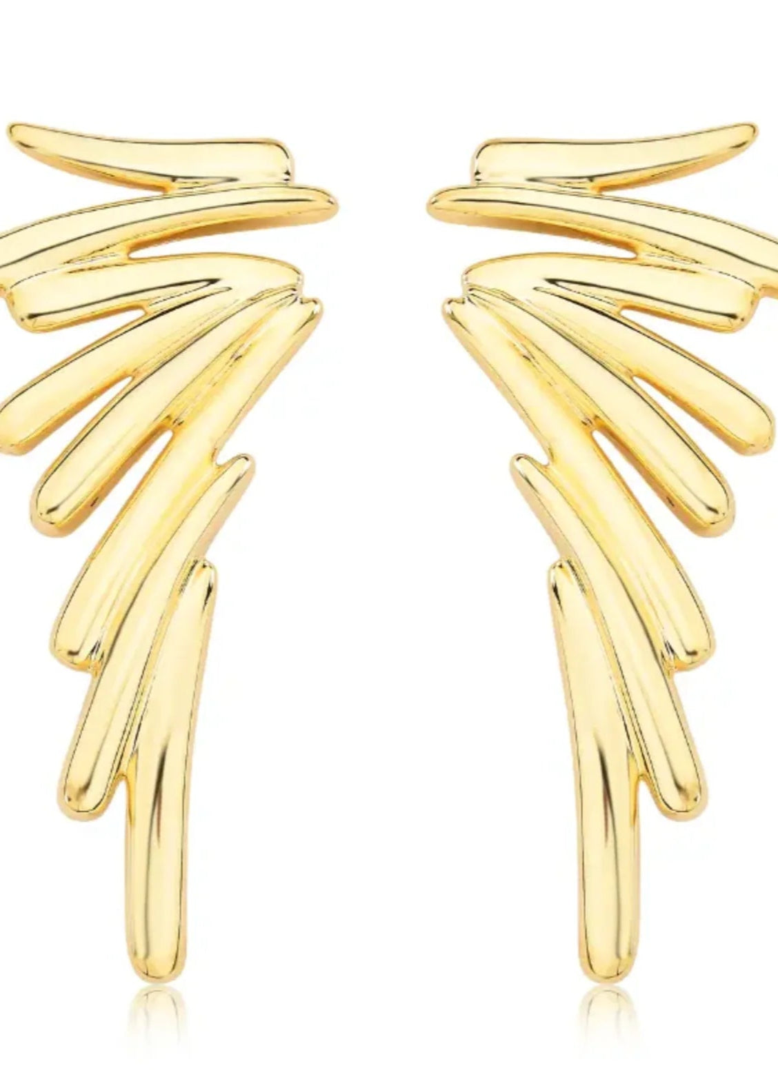 Gold wing-shaped earrings on a white background