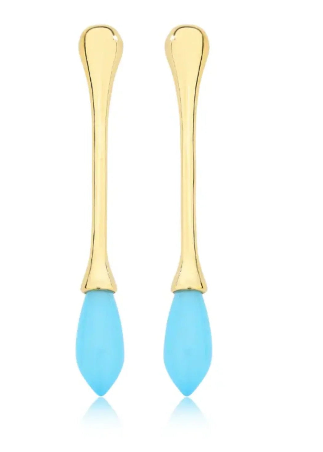 Pair of gold earrings with blue silicone tips on a white background