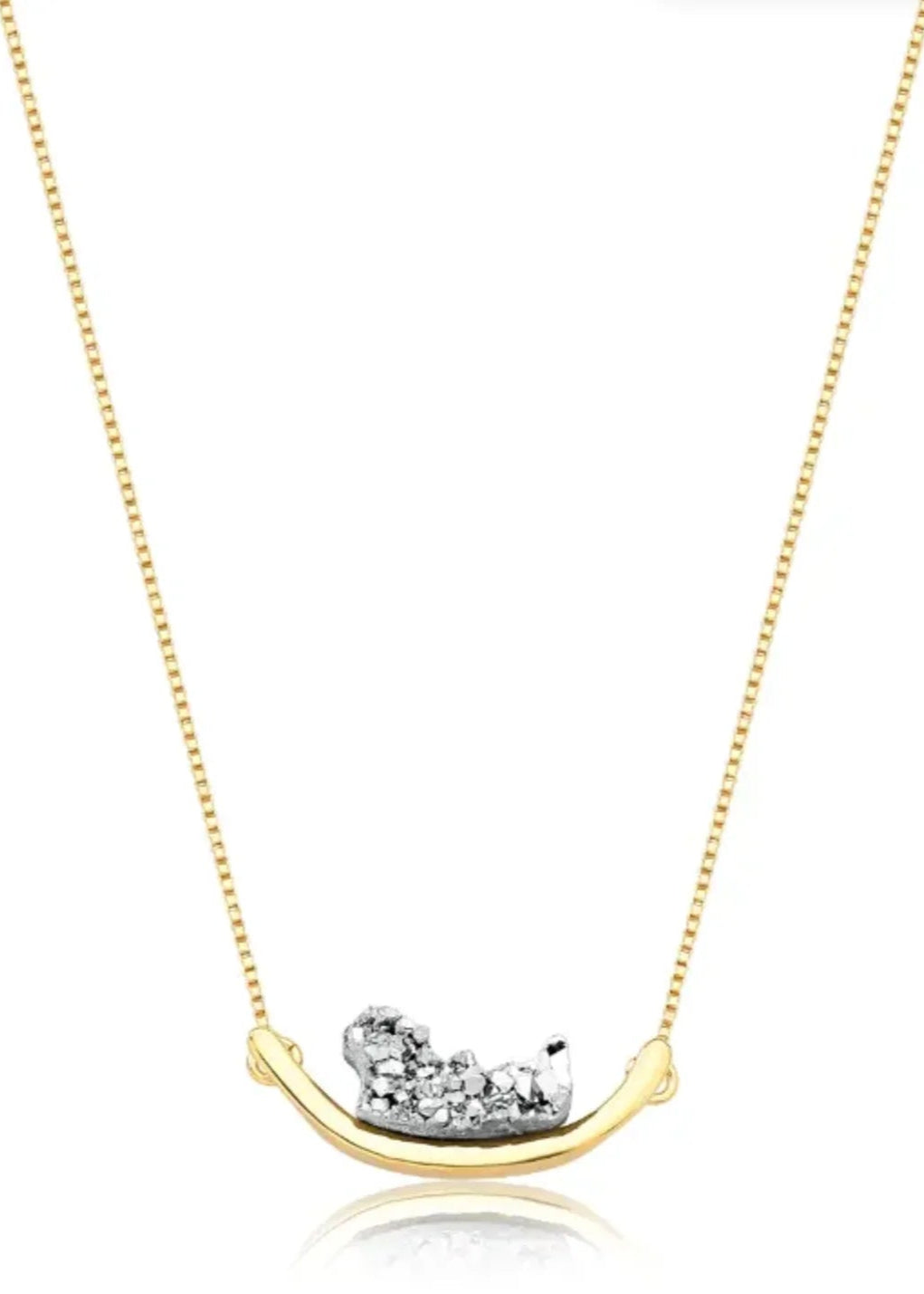 Gold necklace with a unique pendant on a white background