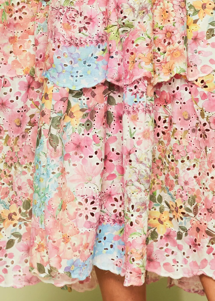Floral dress with a colorful flower detail on a light green background