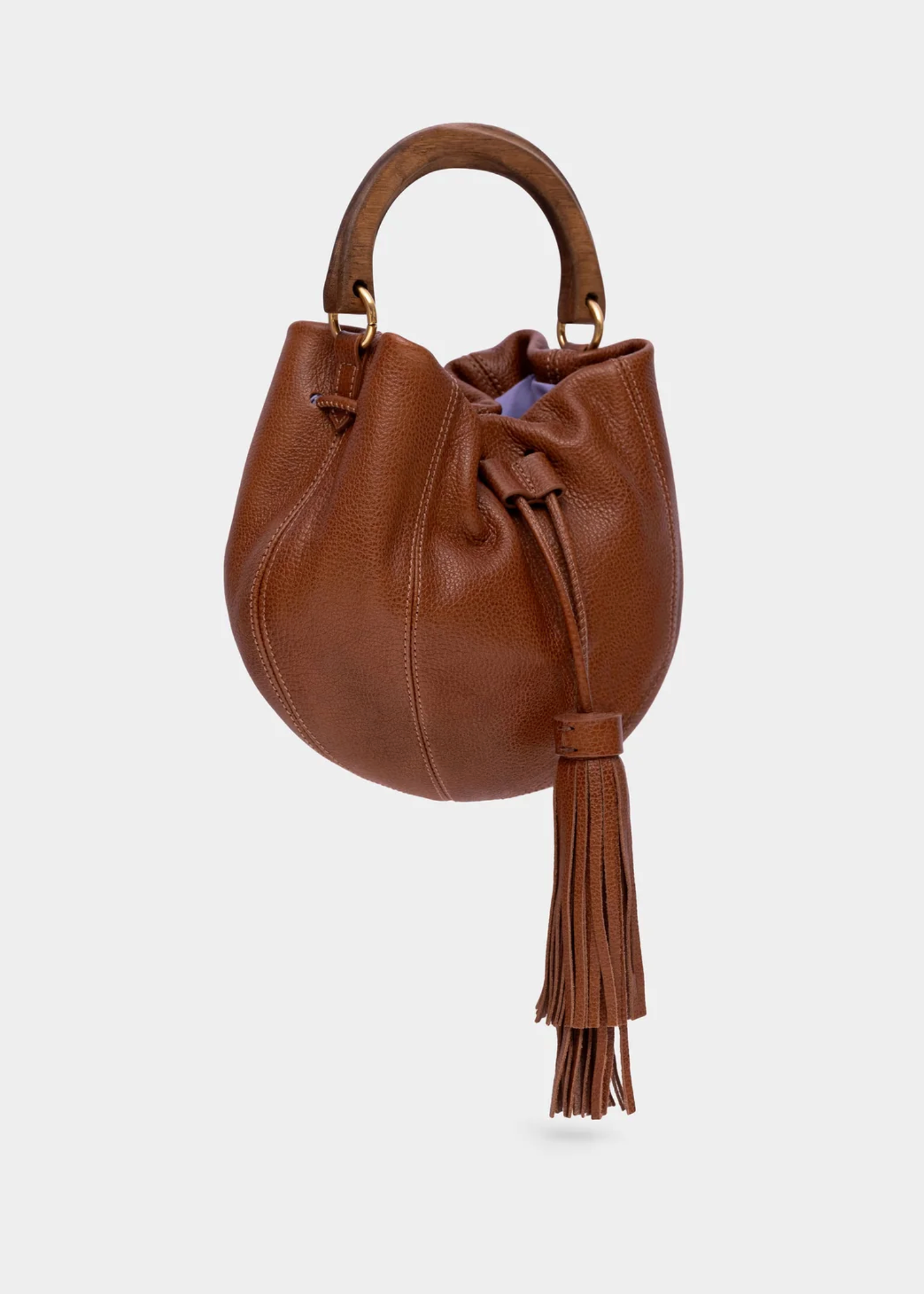 A brown pebbled leather drawstring bucket bag with a top handle and a long tassel, shown against a light gray background.