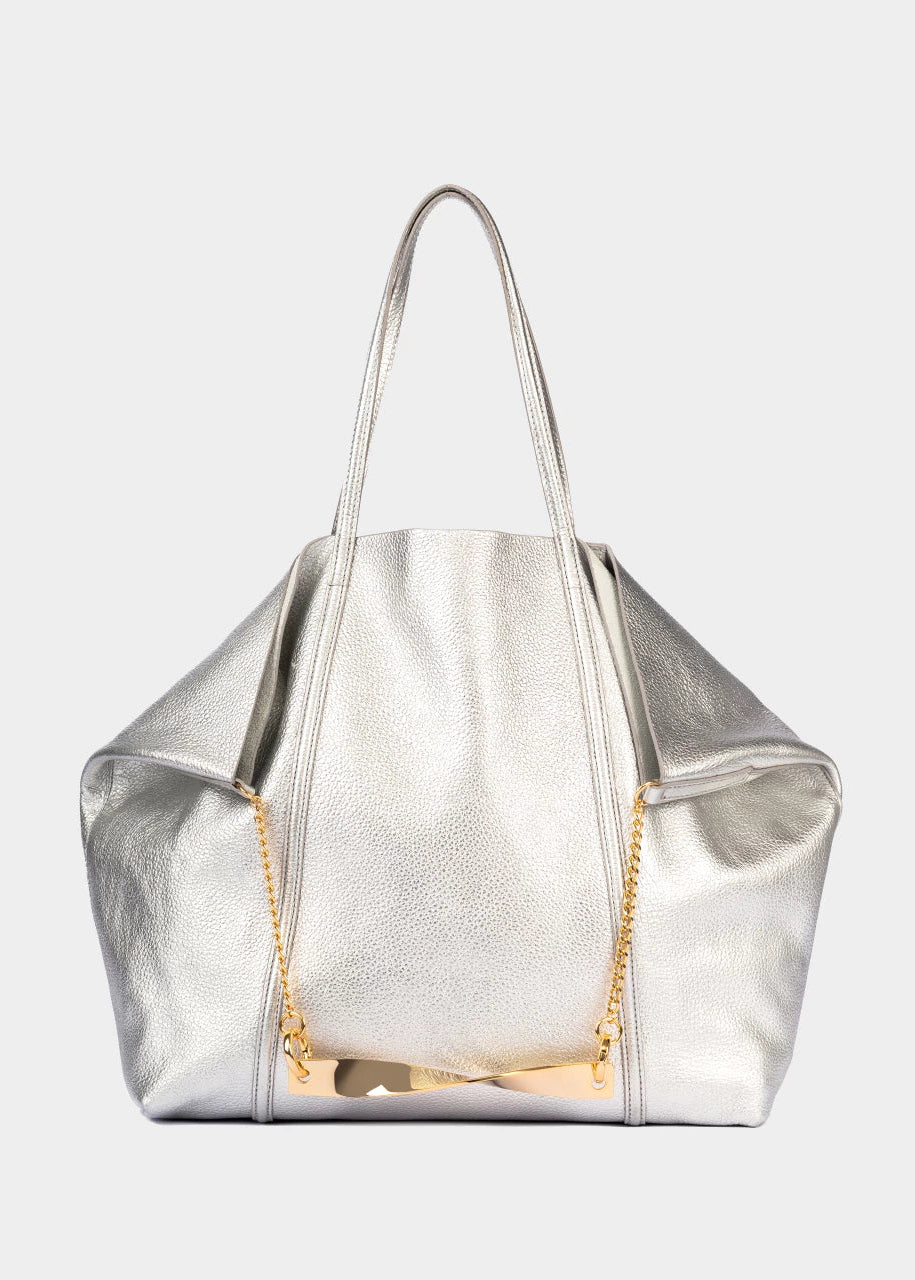 Silver handbag with a gold chain on a light gray background