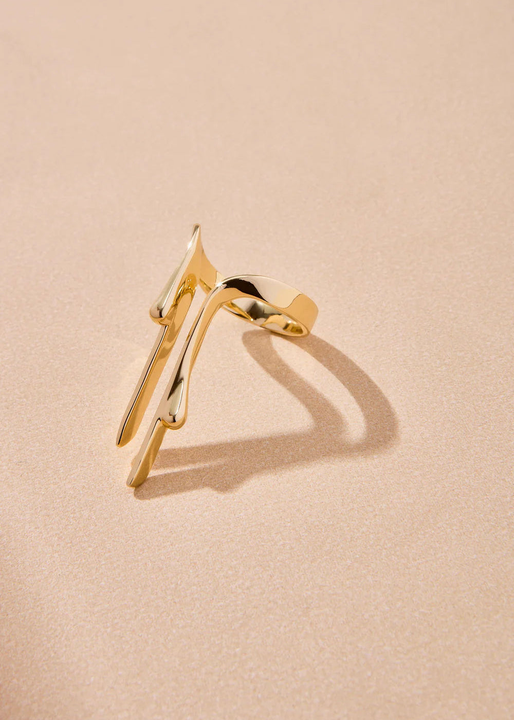 Gold ring on a beige background