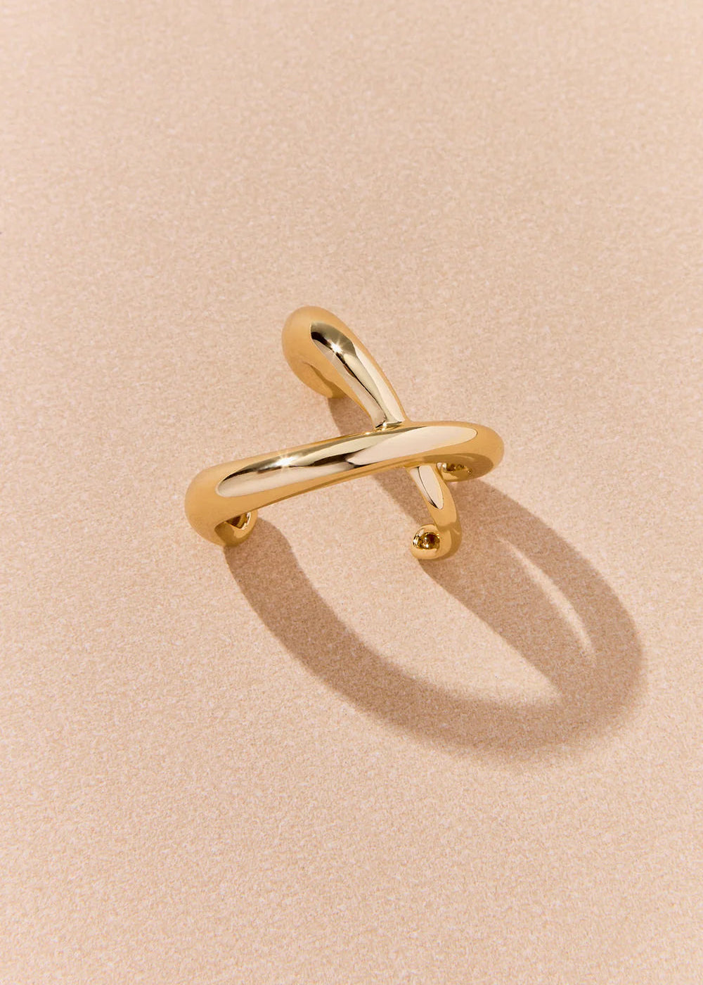 Gold ring on a beige background